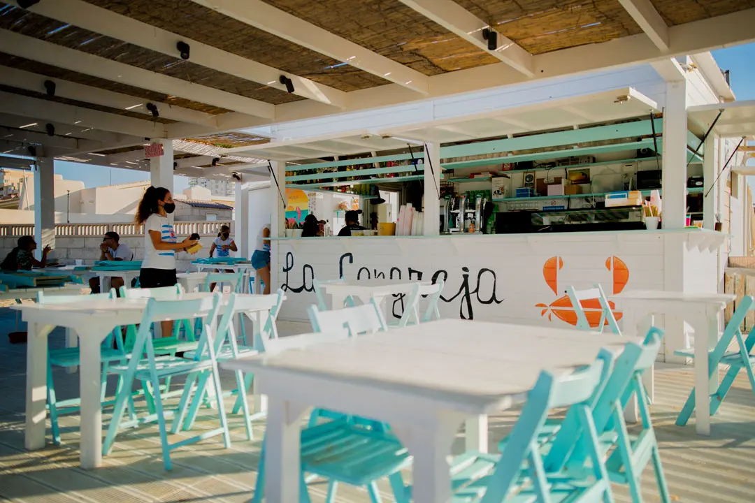 Beach bar terrace with turquoise chairs